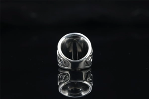 Macro shot of a vintage punk skull ring with blue enamel detailing on polished silver band