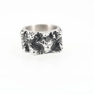 Retro punk style stainless steel mountain ring with rugged rock texture on white background