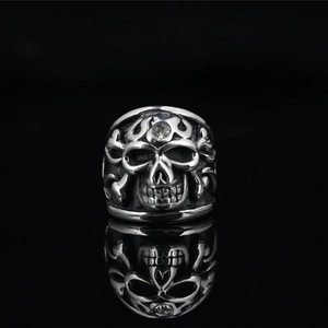 Punk style skull ring in vintage silver finish with crystal inlay on black mirror background