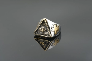 Macro shot of punk style steel ring with Eye of Providence on a gold pyramid