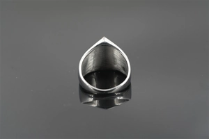 Macro shot of silver punk ring showing brushed metal texture and V-shaped inner structure