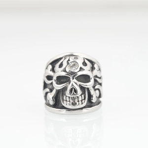 Punk style skull ring in silver steel finish with clear zirconia stone and crossbones