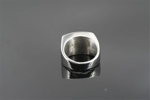 Detailed macro view of brushed inner surface and polished edge of men's steel ring