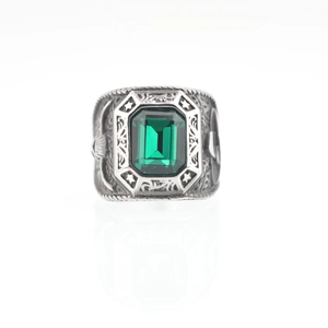 Vintage steel ring with emerald-cut green gemstone and eagle star relief carving