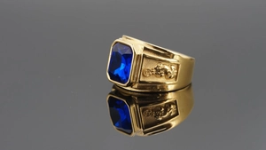 Detailed macro view of gold plated ring featuring a large rectangular blue gemstone