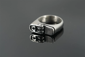 Macro detail of industrial punk lighter-shaped ring with mechanical gears and silver finish