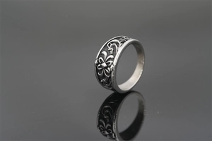Macro detail of retro silver titanium steel ring with floral and scroll engravings