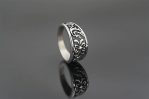 Macro shot of retro titanium steel ring with intricate floral engraving and vintage finish