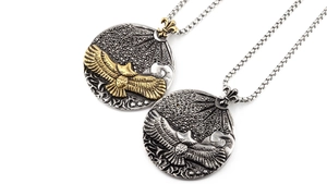 Detailed close-up of eagle relief pendants with black micro-diamonds and iris motifs