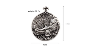 Detailed view of silver eagle round pendant with engraved hawk and fleur-de-lis hook