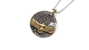 Macro detail of vintage eagle pendant with gold accents and silver textured relief