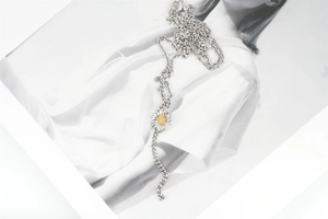 Close-up of the silver daisy pendant necklace showing delicate petals and lobster clasp