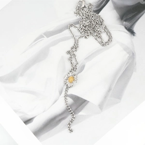 Chic silver titanium sunflower necklace with mixed chains on a fashion magazine background