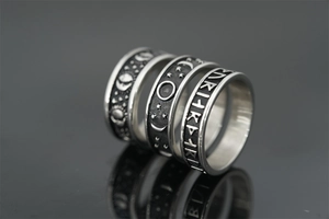 Detailed close-up of retro titanium steel rings featuring celestial stars and moon engraving