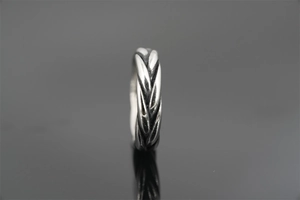 Detailed close-up showing the vintage braided texture and wheat pattern on the steel ring