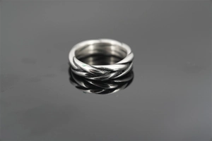 Close-up of vintage twisted rope ring with oxidized texture in durable titanium steel
