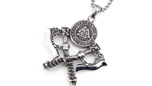 Macro detail of Nordic Viking necklace showing crossed axes and Valknut rune engraving
