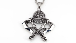Close-up of Norse Valknut pendant with twin battle axes and intricate rune carvings