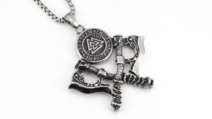 Macro shot of Viking Valknut pendant with Nordic runes and double axes in vintage steel
