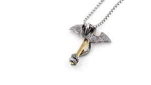 Detailed view of pterosaur sword pendant with golden serpent and vintage titanium steel chain
