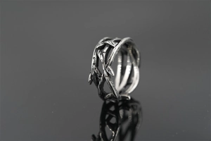 Macro detail of intertwined vintage silver thorn ring with oxidized metal textures