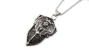 Close-up of vintage silver lion head shield pendant with intricate relief and square chain