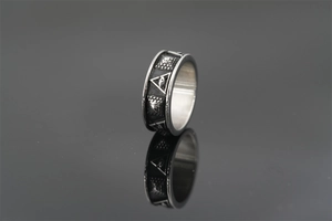 Macro detail of gothic titanium steel ring featuring All-Seeing Eye and pyramid carvings