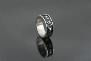 Detail of vintage silver titanium steel ring with pyramid and Eye of Providence symbols