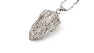 Detail of silver shield pendant showing honeycomb texture and robust box chain necklace