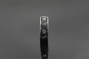 Macro detail of retro steel ring featuring embossed Eye of Providence and pyramid texture