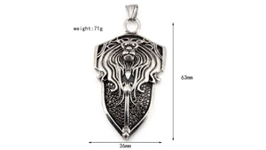 Detailed relief of lion head shield pendant with black stones and silver finish