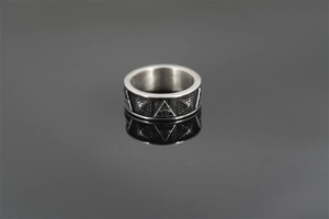 Macro shot of gothic titanium steel ring featuring an engraved eye within a triangle