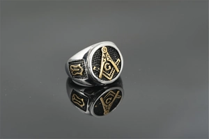 Macro shot of silver and gold Masonic ring with square, compass and G symbol detail