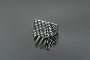 Detail of vintage silver signet ring for men with punk style dotted texture and polished finish