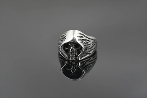 Macro detail of vintage punk skull ring with embossed reaper design in distressed silver