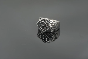 Macro shot of vintage nautical ring featuring a central compass emblem and scaled texture