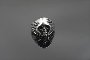Macro view of vintage gothic grim reaper skull ring with black oxidized finish on mirror