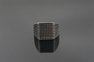 Macro view showing the vintage textured dot pattern on this men's titanium steel square ring