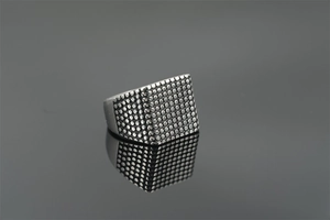 Macro detail of men's titanium steel signet ring featuring a textured square dotted surface