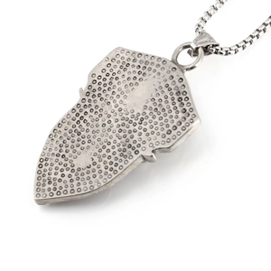 Silver retro arrowhead pendant necklace with industrial dot texture on white background