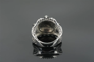 Macro view of vintage silver ring with skull design and hollow-out band craft