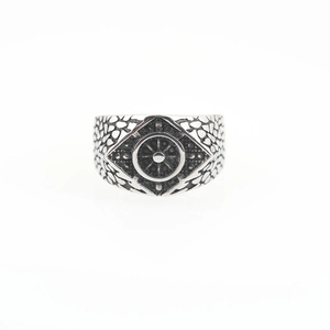 Punk style vintage silver ring with a ship wheel design on a rough textured metal band