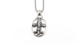 Detailed close-up of retro silver fleur-de-lis pendant on a stainless steel box chain