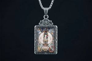 Detail of silver rectangle Thangka pendant featuring colorful Avalokitesvara Buddha icon