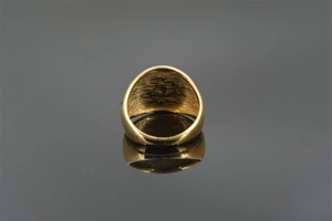 Detailansicht eines vergoldeten breiten Ringes mit poliertem Finish und innerer Textur