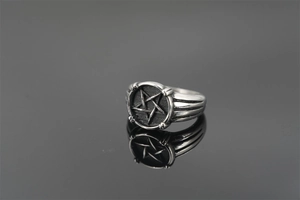 Macro shot of retro stainless steel star ring with antique finish and relief texture
