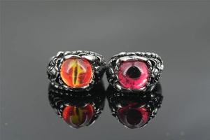 Macro shot of punk gothic steel rings with dragon eye stone and claw scale details
