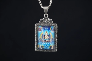 Macro shot of Buddhist Thangka pendant in silver titanium steel with intricate relief