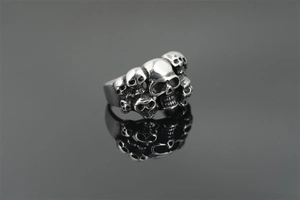 Macro view of vintage silver punk skull ring with detailed engravings and heavy metal texture