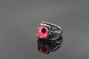 Gothic style red evil eye ring with claw-like metal textures and a weathered silver finish